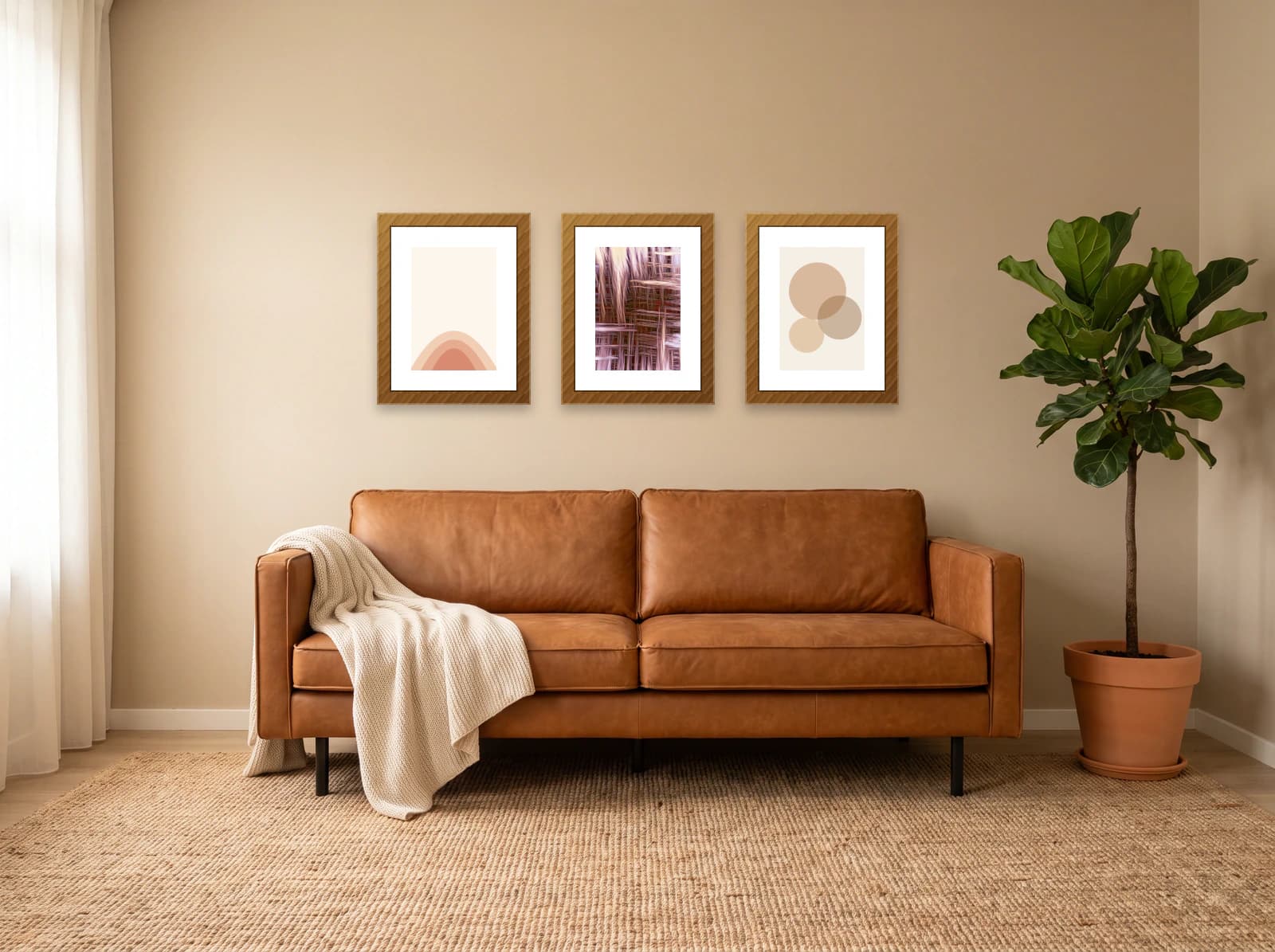 Three framed prints above a leather sofa